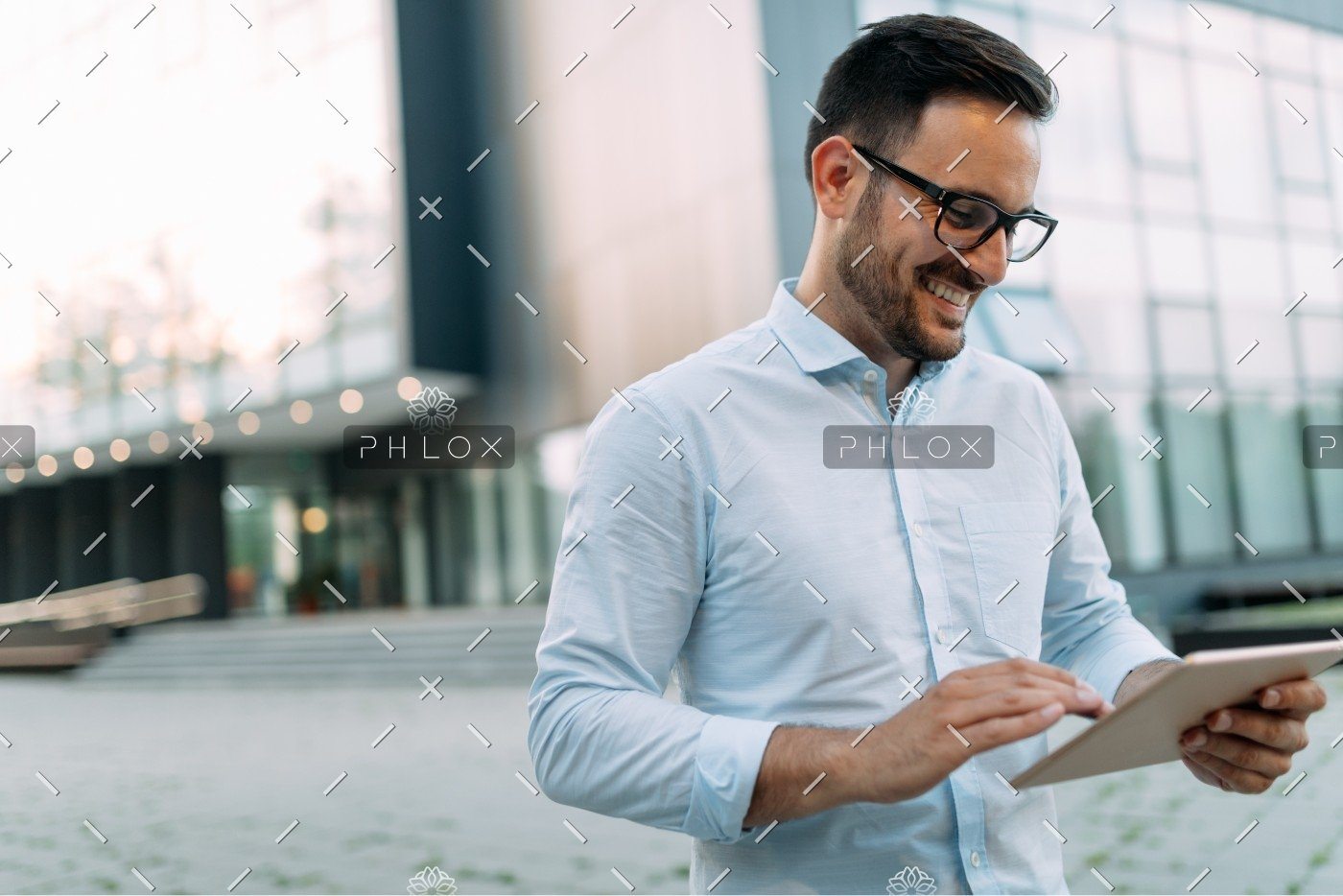 demo-attachment-336-portrait-of-businessman-in-glasses-holding-tablet-AWVHCJU